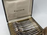 an image of a box of silverware with a spoon and spoon rest in it