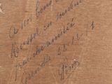 a piece of wood that has writing on it
