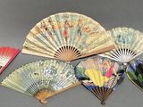 several different types of paper fans on a gray surface