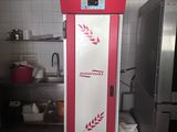 a red and white refrigerator in a kitchen next to a stove