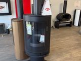 a black stove in the middle of a room
