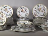 many plates and cups and saucers with flowers on them