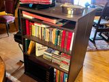 a bookshelf with a lot of books on it in a room
