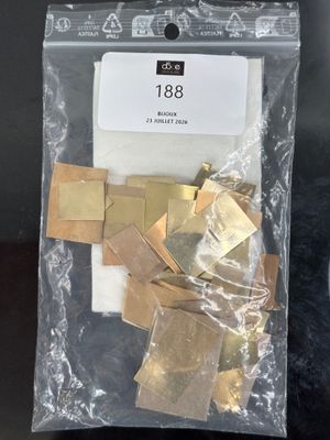 a close up of a bag of gold pieces on a table