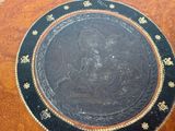 a black plate with a picture of a woman on it