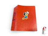 mickey mouse sticker on the back of a red book