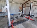 a picture of a garage with two jacks in the middle of it