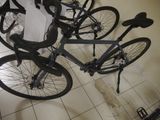 several bikes are lined up on a tiled floor in a room