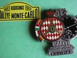 two badges of different colors and designs on a green surface
