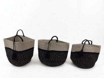 three black and white baskets with handles on a white background