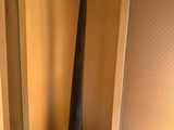 an elephant horn on a stand in a corner of a room