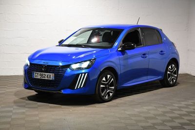 a blue car parked in a garage with a checkered floor
