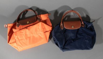 two purses that are sitting on a table