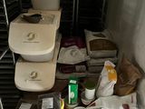 many containers and containers of food sitting on a shelf