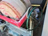 a cement mixer that is sitting in the dirt