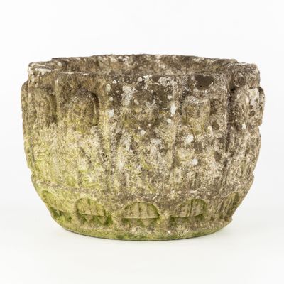 a stone planter that has moss growing on it