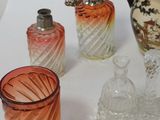 many different colored glass vases on a white table