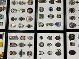 a lot of pins and brooches that are on the floor
