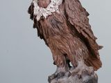 a statue of a bird on a rock on a table