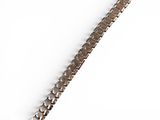 an image of a close up of a metal bracelet on a white surface