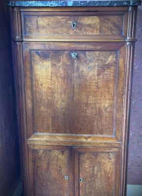 a wooden cabinet with a marble top in a room