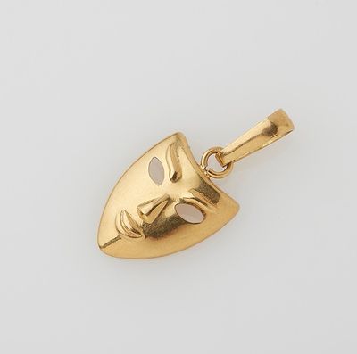 an image of a gold mask pendant on a white background