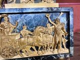 a statue of a man riding a horse drawn carriage