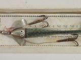 a box with a lure in it on a white surface