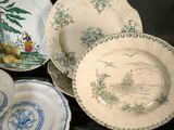 many plates and bowls that are sitting on a table