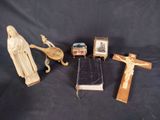 several religious items including a crucif, a book, and a statue