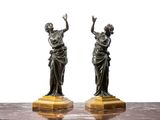 pair of antique bronze figurines of a woman and a man