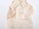 a statue of a woman with a bird on her head