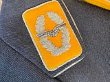 a small patch on the lapel of a man ' s jacket