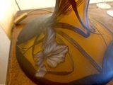 a vase with a design on it sitting on a table