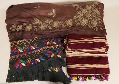 several different types of scarves are laid out on a table