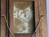 a picture of a wooden frame with a rope on it