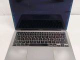a laptop computer sitting on a table with a keyboard