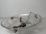 a glass plate with a bird on it sitting on a table