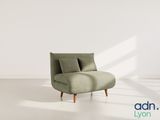 an image of a green chair in a white room with a window
