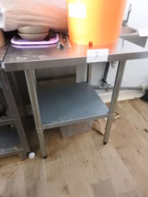 a table with a bowl on it and a bucket on it