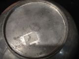 a close up of a metal pot with a tag on it