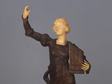 statue of a woman holding a musical instrument in her right hand