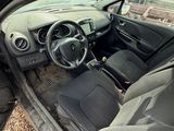 a car with the door open sitting on the gravel