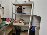 a room that has a shelf with tools on it