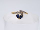 an image of a diamond and sapphire heart ring