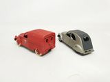 two toy cars sitting next to each other on a white surface
