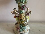 a vase that has a bunch of figurines on it