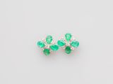 a pair of emerald and diamond earrings
