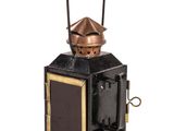 an old fashioned copper and black lantern on a white background