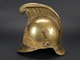 brass plated helmet with a cross on the side of the helmet